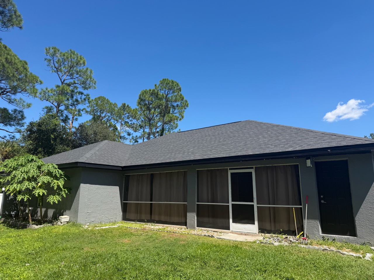 Completed shingle roof above the rear screened patio of a North Port, Florida home.